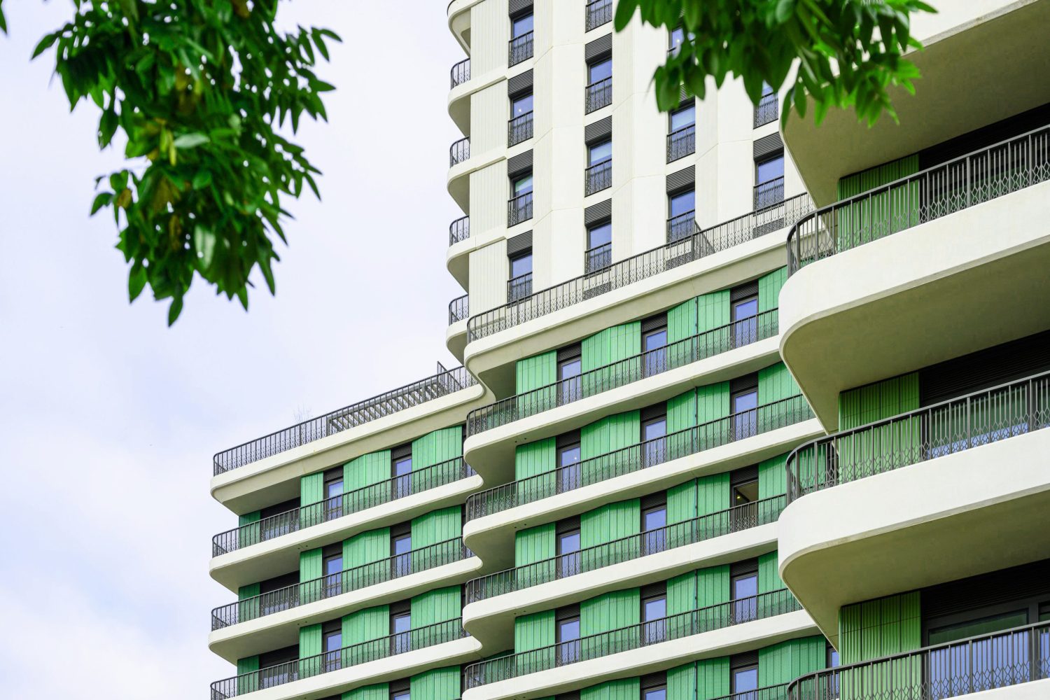 Exterior section of Sutherland Apartments at Ebury showing distinctive curved architecture and green facade detail